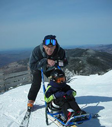 Dr. Medaugh sledding with his son