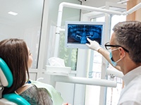 implant dentist in Belchertown showing a patient their X-rays 