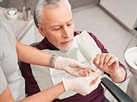 Man with dentures at the dentist