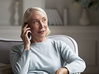 Mature woman conversing on telephone