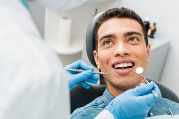 Dentist and Patient in chair smiling