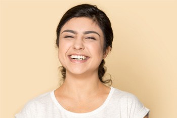 woman pulling back cheek to reveal a missing tooth
