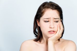 Woman with jaw pain