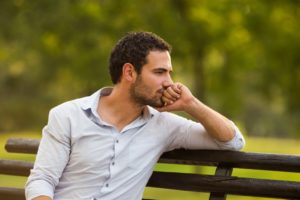 Man sitting on a bench thinking.