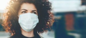 Woman properly wearing a face mask as instructed by Belchertown dentist