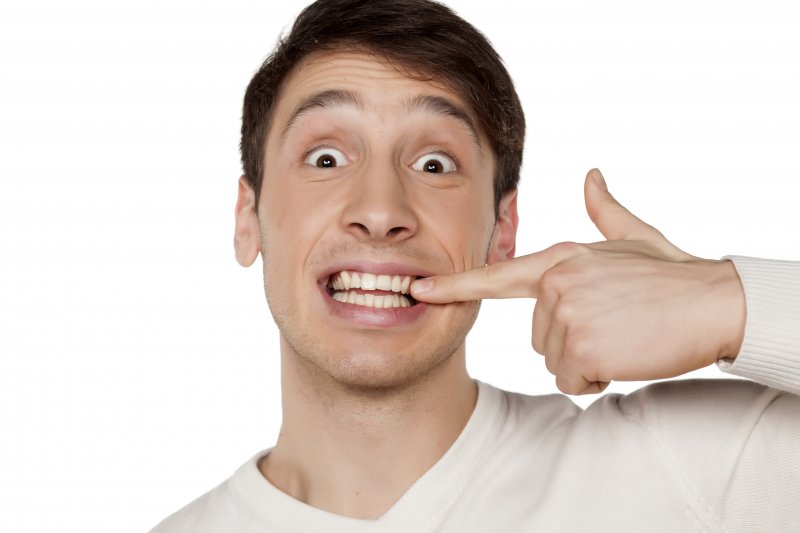 man pointing to dental implant in Belchertown