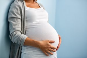 Pregnant woman holding her belly