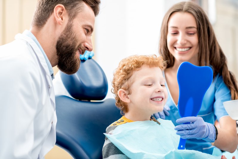 child smiling at appointment after getting dental sealants