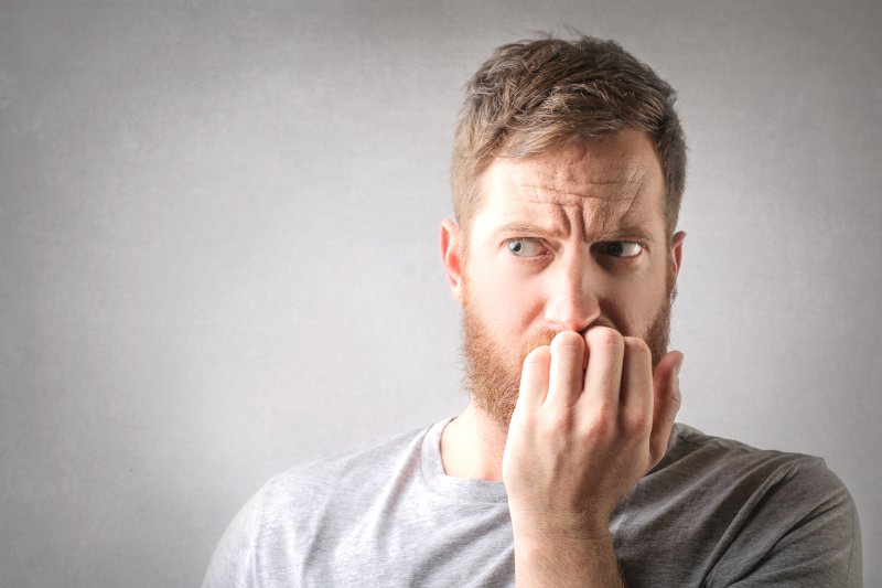 Man biting fingernails